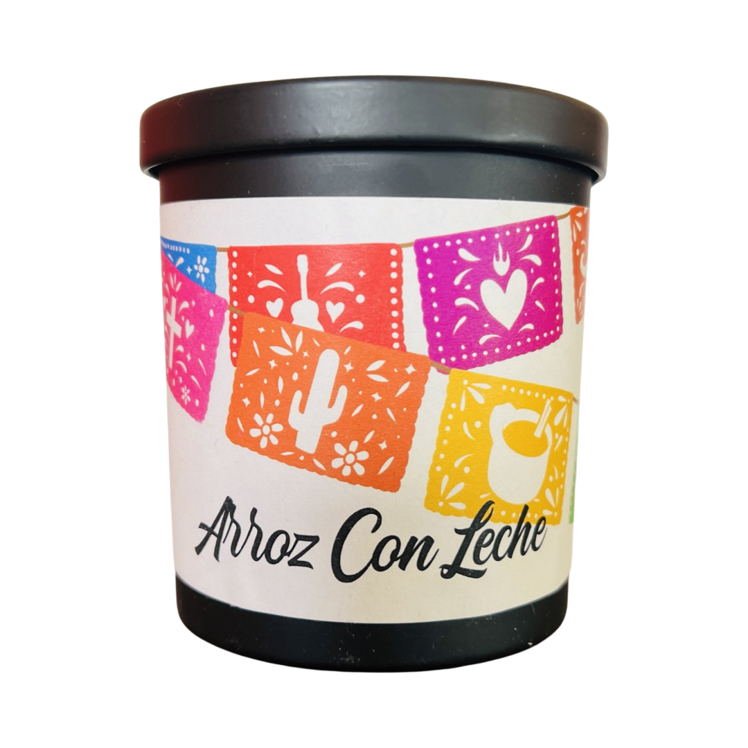 black jar with a beige branded label that features colorful papel picado and the name of the candle in black lettering