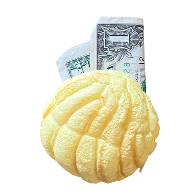 yellow rubber concha coin purse with a dollar