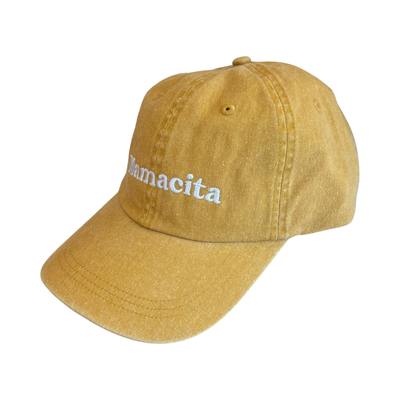 side view of a mustard hat with the word Mamacita in white lettering