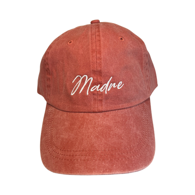 coral hat with the word Madre in white lettering