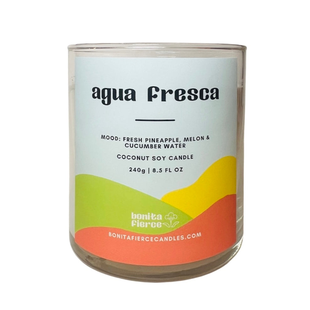 8.5 oz glass agua fresca candle with a branded label in shades of green, light blue and yellow.