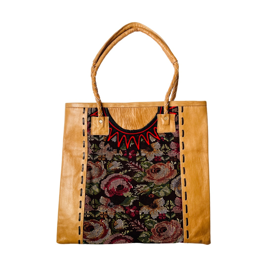 Huipile and leather tote bag that features recycled mayan blouse fabric with a flower designand leather handles.