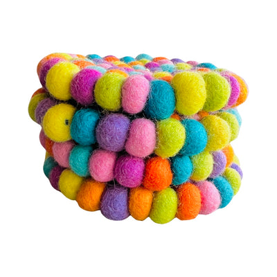 set of four round pastel multi-colored felt pom pom coaster