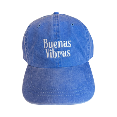 front view of a blue hat with the phrase Buenas Vibras in white lettering