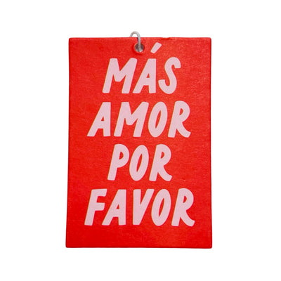 Rectangular air freshener with "Más Amor Por Favor" written in bold letters; red background with light pink text