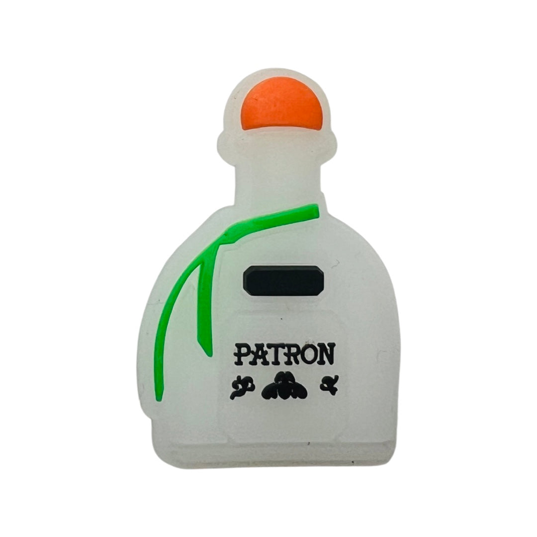 White patron tequila bottle with a green ribbon and the word Patron in black lettering chancla, or croc, charm.