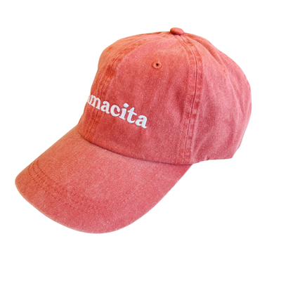 side view of a coral hat with the word Mamacita in white lettering