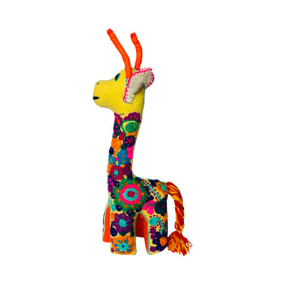side view of a yellow embroidered giraffe with colorful flowers