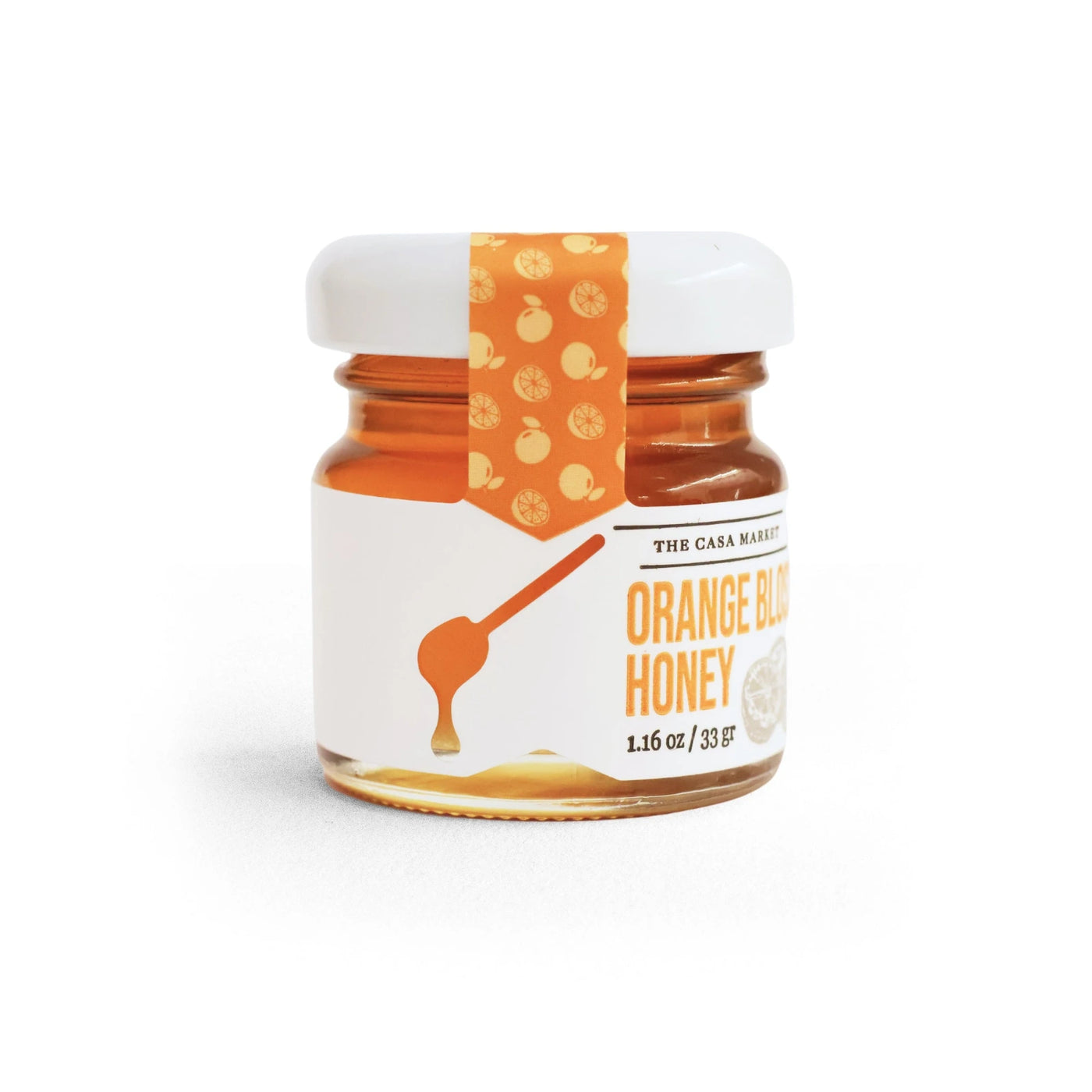 A small glass jar of Orange Blossom Honey from The Casa Market, featuring golden amber honey with a white label displaying an orange spoon illustration and citrus-themed decorative seal on the lid. The jar contains 1.16 oz (33g) of honey.