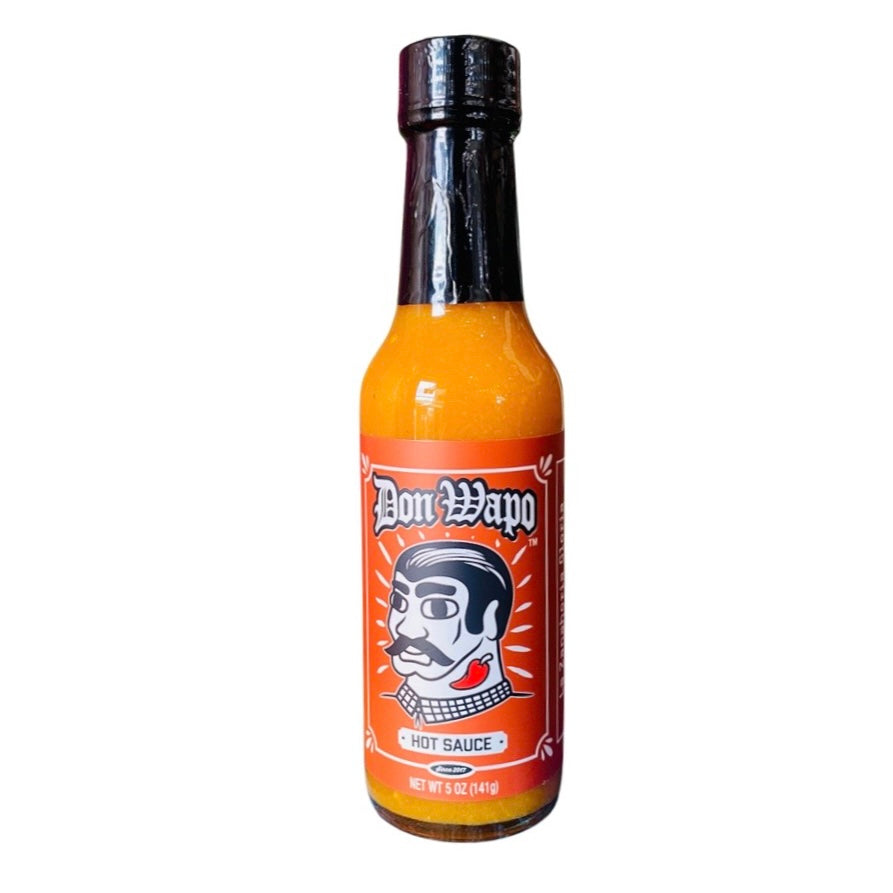 front view of Don Wapo Hot Sauce- La Zanahoria packaged in a clear glass branded bottle