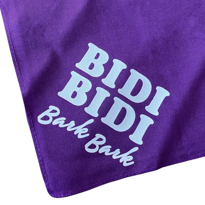Up close view of "bidi bidi bark bark" purple dog bandana.