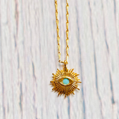 Close up of gold plated brass evil eye protection necklace.