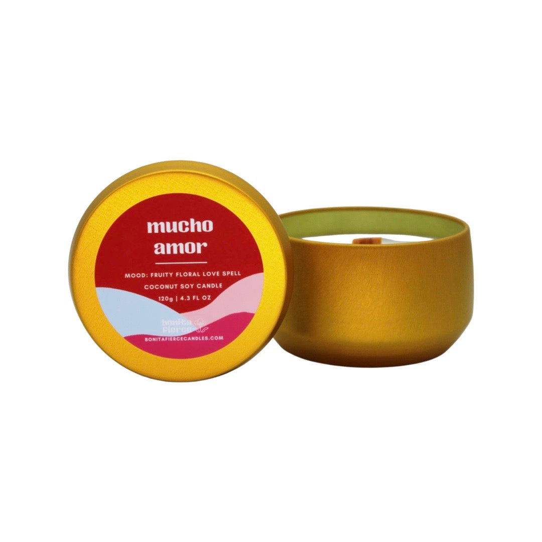 gold tin candle with a red and pink colored branded label with the phrase Much Amor. Translation: A lot of love