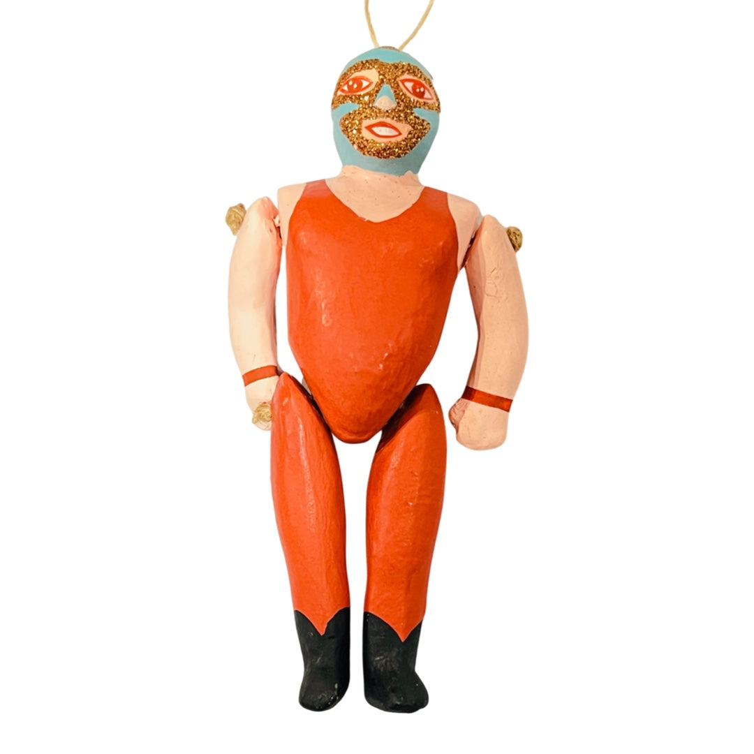 Paper mache style luchador ornament with dark blue & orange glitter mask & orange leotard