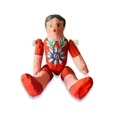 Paper Mache Muñeca (Doll) with movable arms and legs. Doll is featured in an orange dress.
