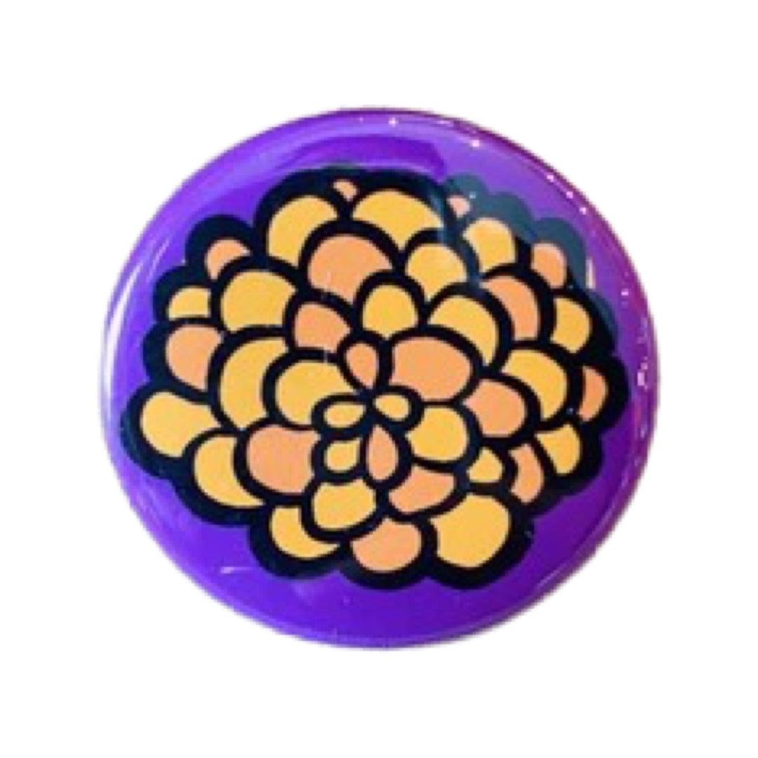 Pueple round pin button with an orange marigold