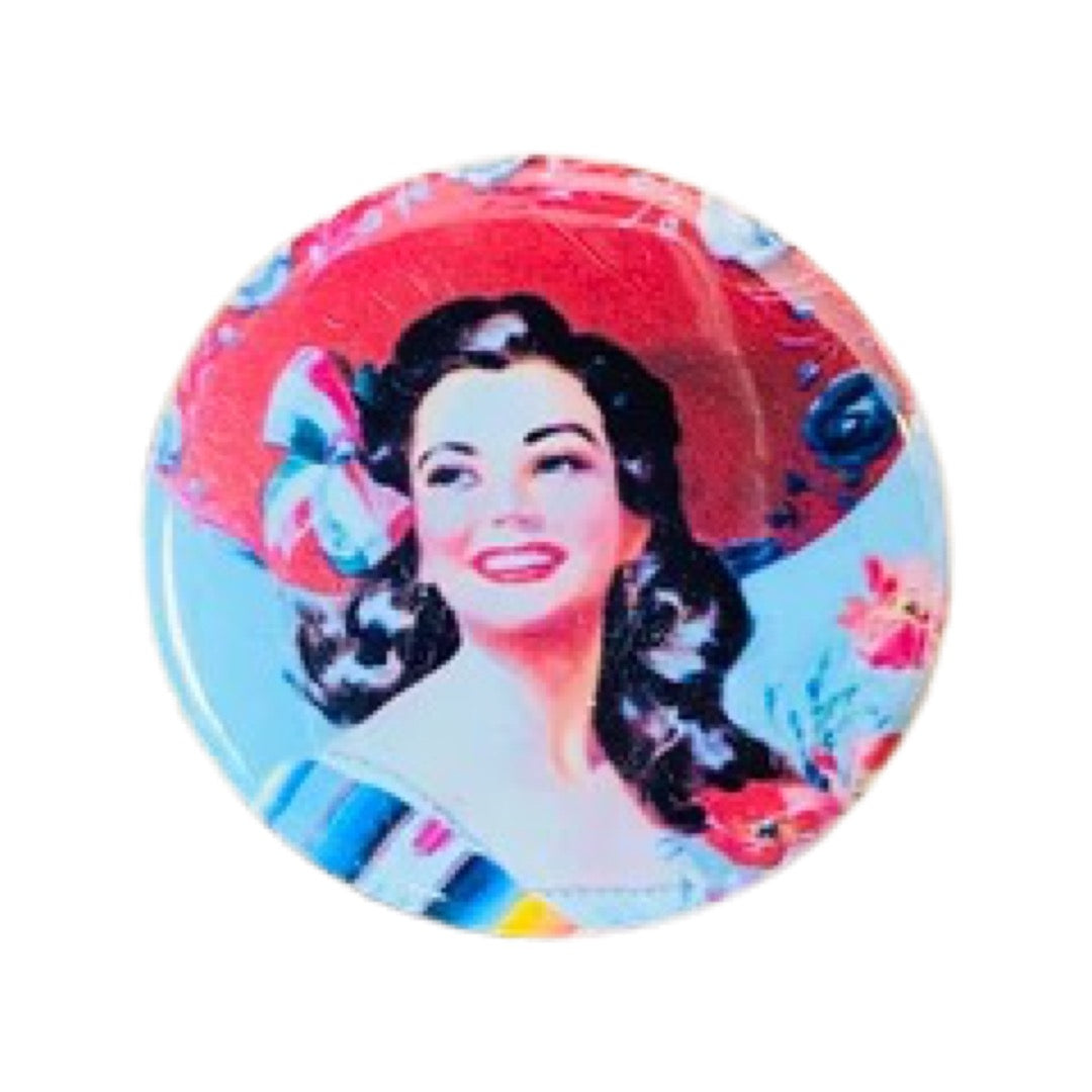 Round pin button with an image of a woman wearing a sombrero