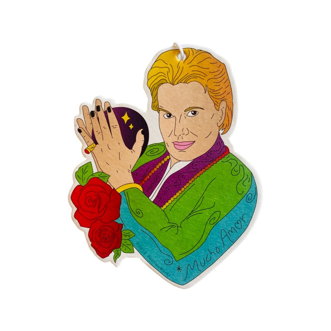 Walter Mercado holding a crystal ball with roses as an air freshener.