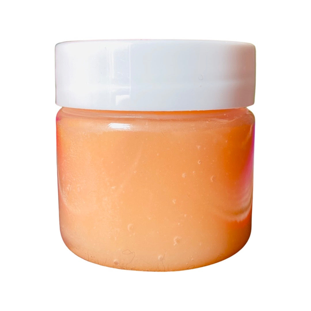 Side view of melon lip scrub in clear jar with lid.