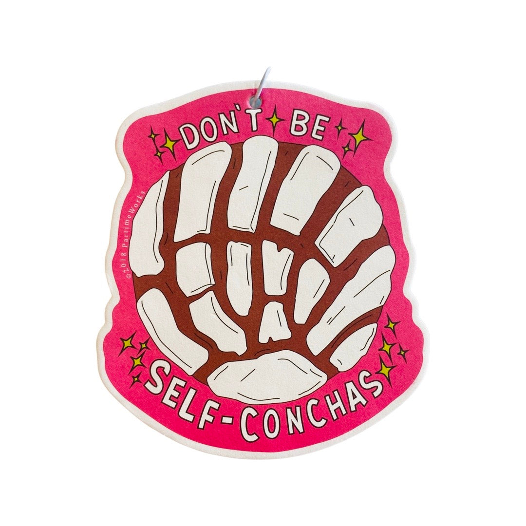 Pink air freshener with a white concha and the phrase Don't Be Self-Conchas.