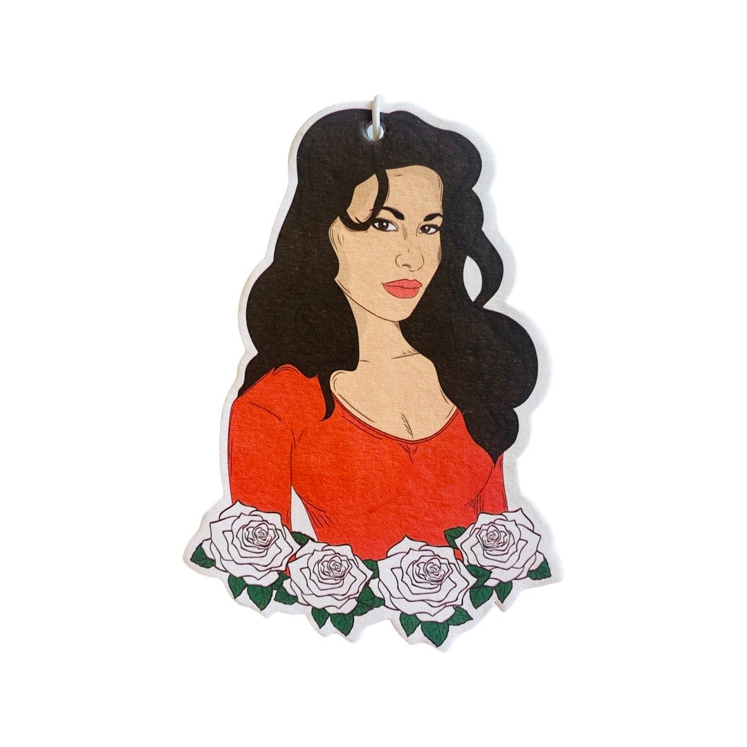 Selena Quintanilla in red top with white roses.