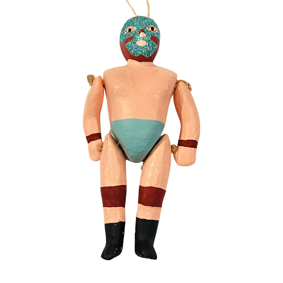 Paper mache style luchador ornament with dark red & blue glitter mask & blue underwear