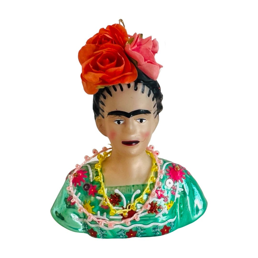 Hand-painted glass Frida ornament in green. Frida is wearing a flower (red roses) crown and green traditional blouse.