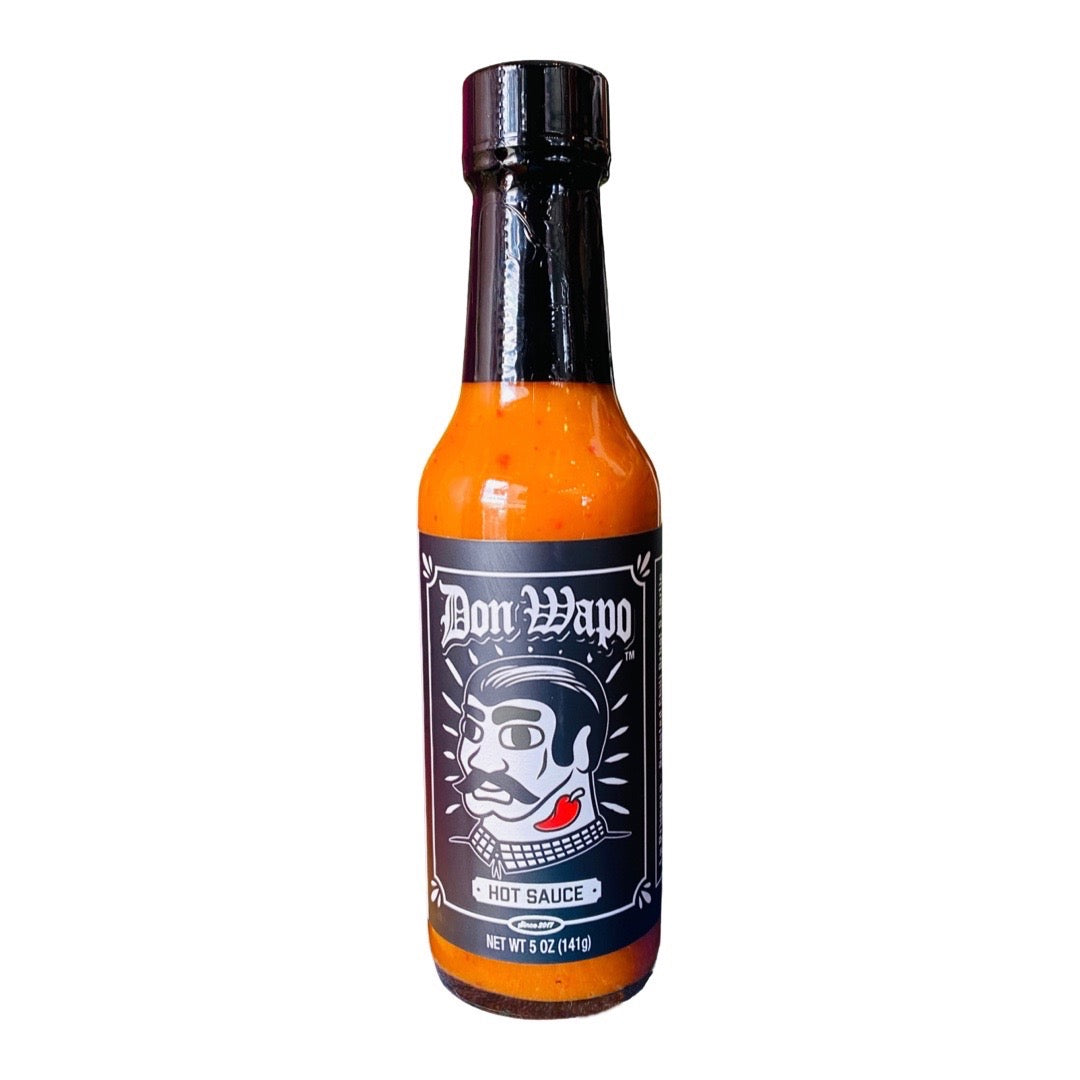 front view of Don Wapo Hot Sauce- La Primera: Roasted Chili Arbol & Garlic packaged in a clear glass branded bottle