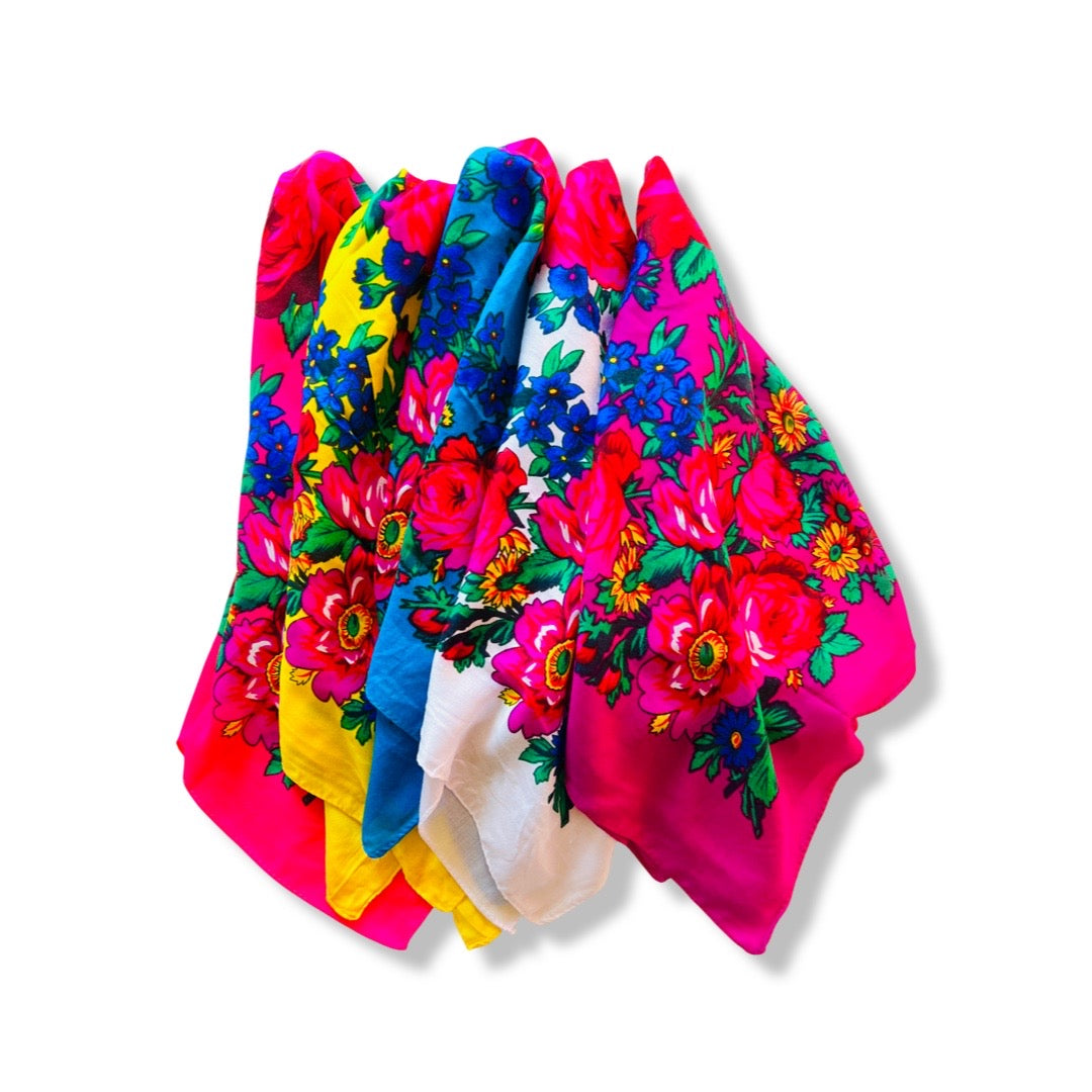 Colorful floral scarves in fuchsia, yellow, blue, white, and pink. 