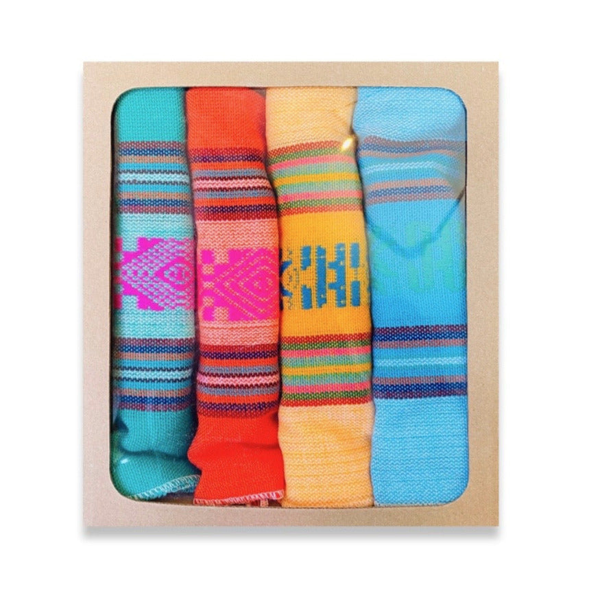 set of four brightly colored napkins in the neon colors green, orange, yellow and blue with multi-colored designs.