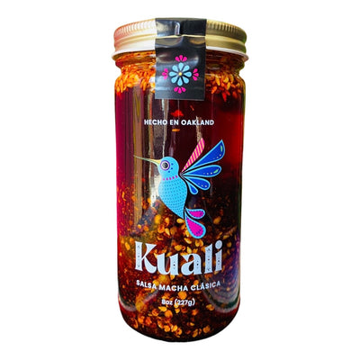 front view of Kuali Salsa - Macha Clasica packaged in a clear glass branded bottle.