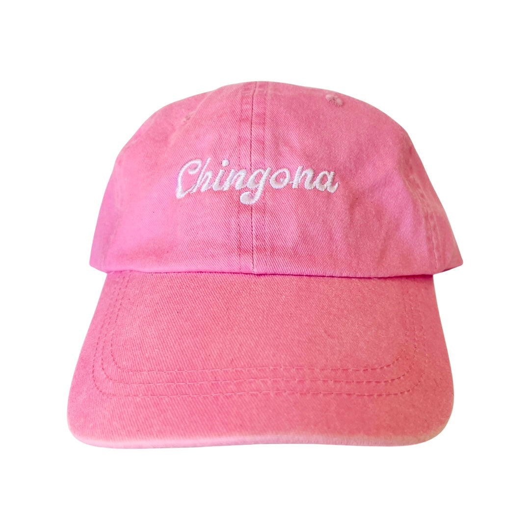 Light pink dad hat with the word Chingona in white lettering