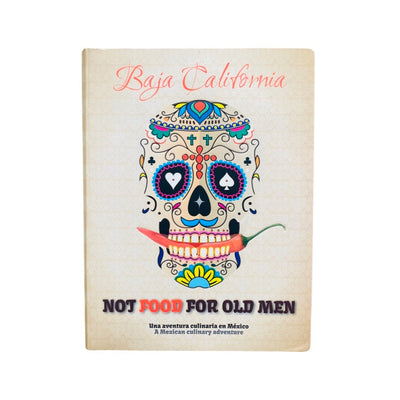 The image displays the cover of a book titled 'Baja California - Not Food for Old Men'. The cover features a flexicover design with a vibrant and colorful illustration of a skull, stylized in the manner of a calavera, with intricate patterns and a chili pepper.