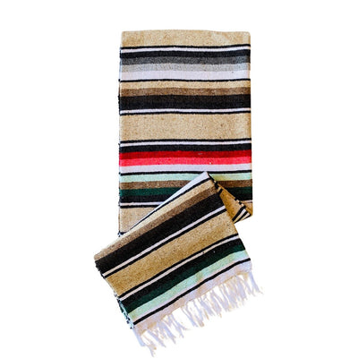 Sand colored serape striped blanket folded in half.