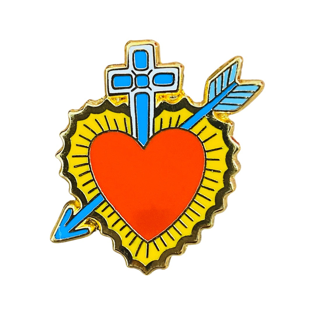 Red and gold sacred heart enamel pin with a blue cross and arrow going through it