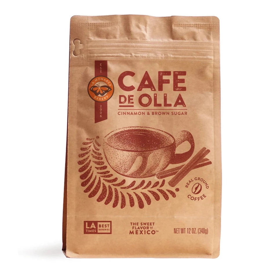 La Monarca Bakery Café de Olla in branded paper bag. Design features cup of coffee with cinnamon sticks.