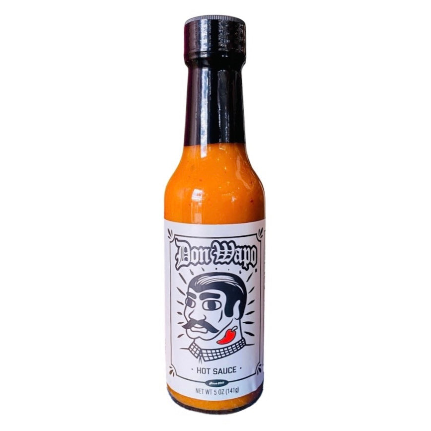 front view of Don Wapo Hot Sauce- Salsa de Ajo Callejera packaged in a clear glass branded bottle