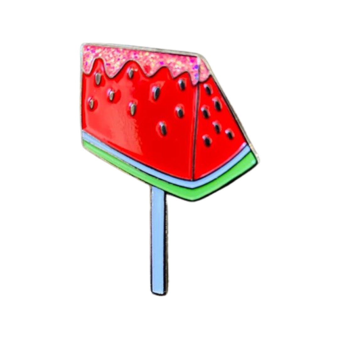Red watermelon slice on a lollipop stick with pink glitter on top.