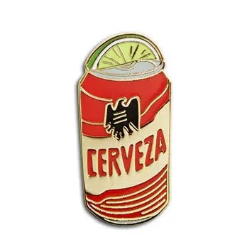 Enamel pin of a beer can with the phrase Cerveza and featuring a lime wedge
