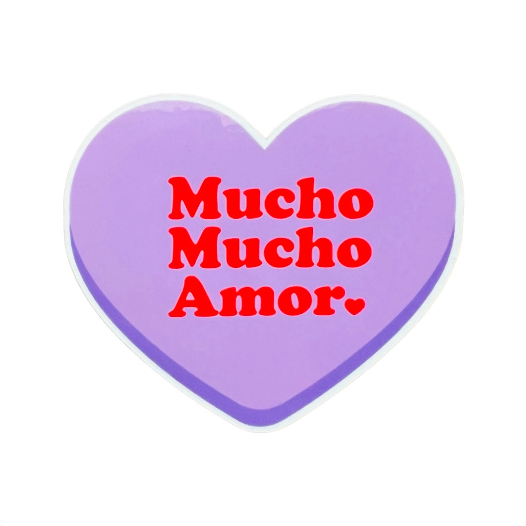 Purple heart with the phrase Mucho Mucho Amor in red lettering. Translation: Lots and Lots of love