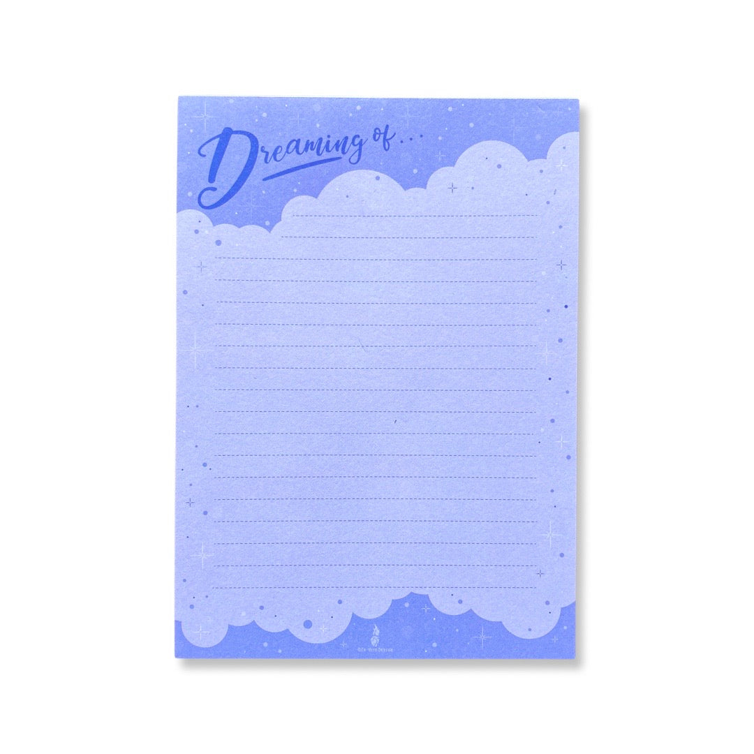 Dreaming Of...phrase notepad. Design features cloud and sparkling stars with purple background.
