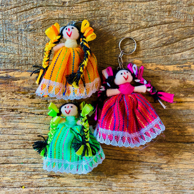 3 Small Mexican woven ragdolls on a keychain in yellow, pink and green styles.
