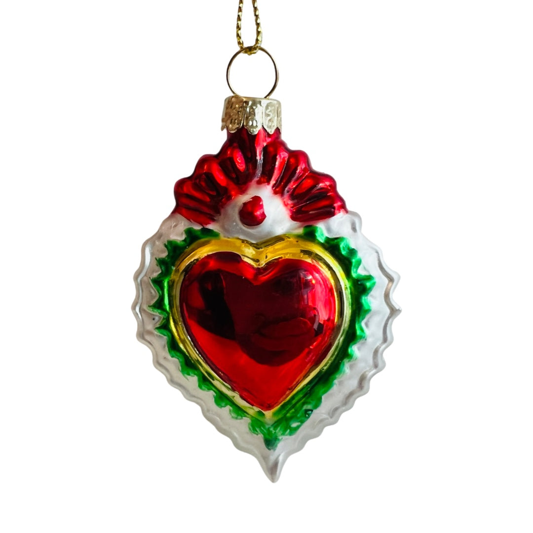 Hand-painted glass milagro heart (style 3).  Red heart features 3 different colored borders. Colors of ornament include: red, green, gold, and white. 