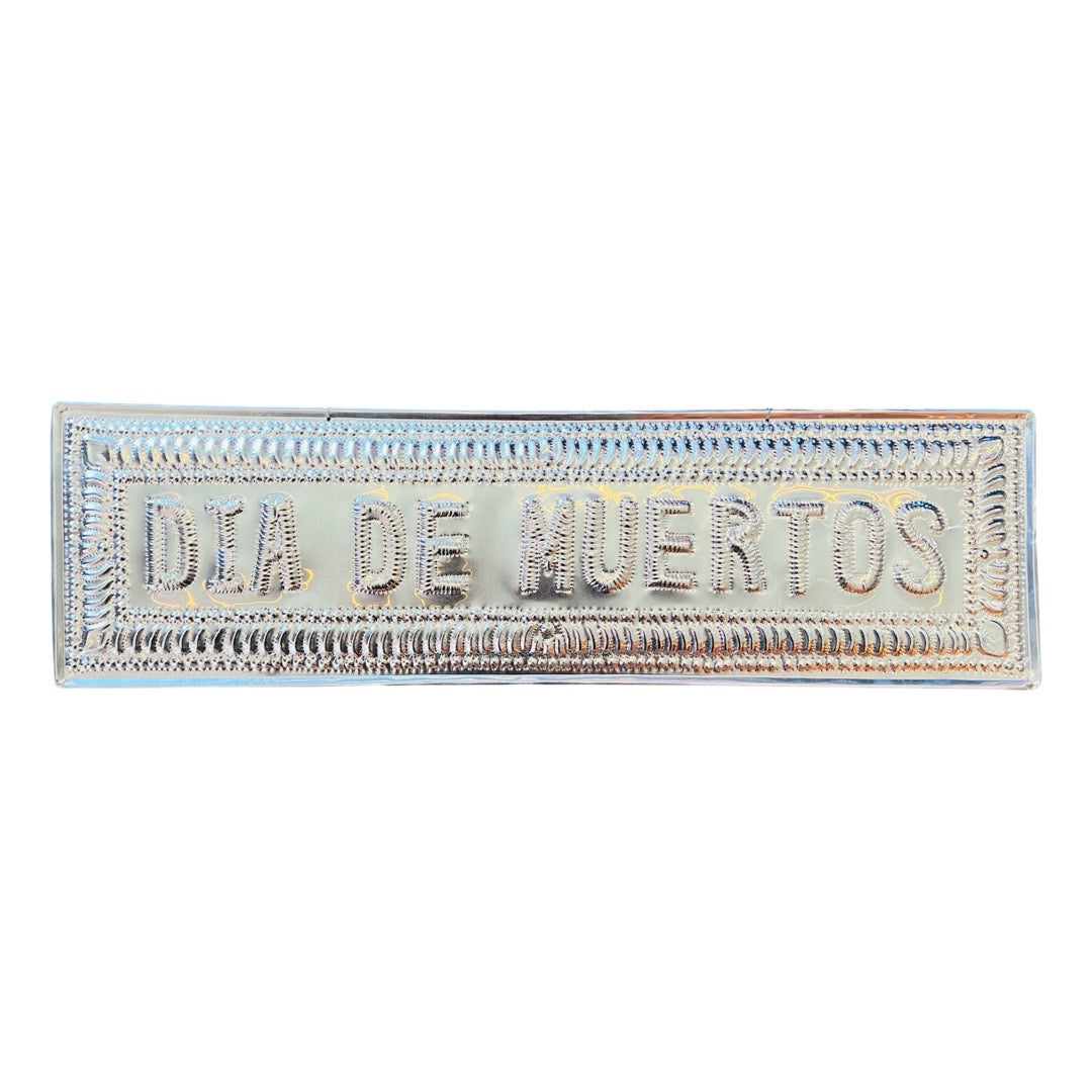 Hammered aluminum sign with the phrase Dia de Muertos, translation: day of the dead