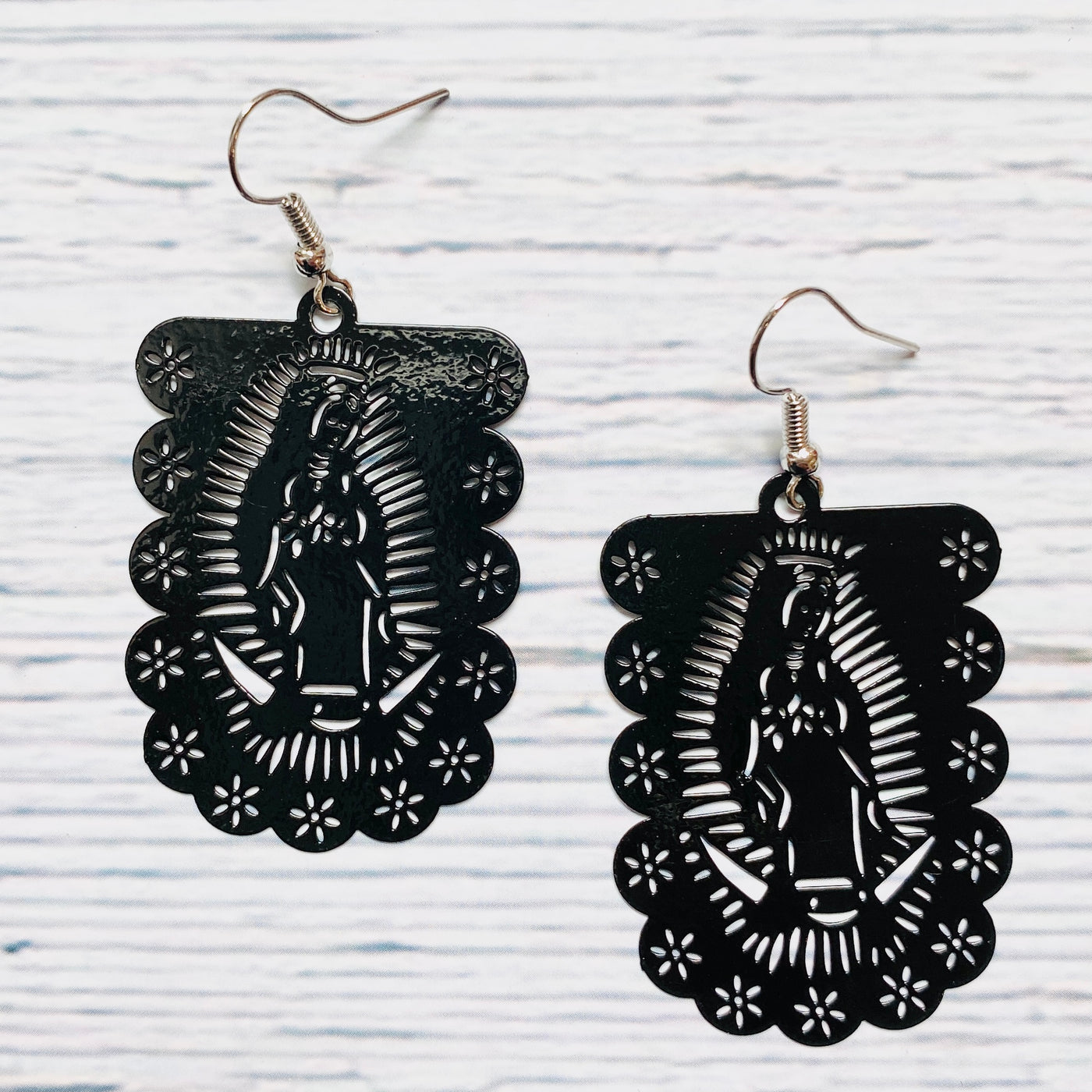 Black laser cut metal Virgen de Guadalupe earrings.