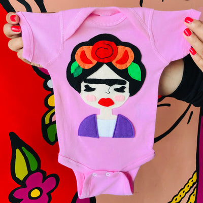 Handmade and hand-stitched Frida Kahlo baby pink onesie.