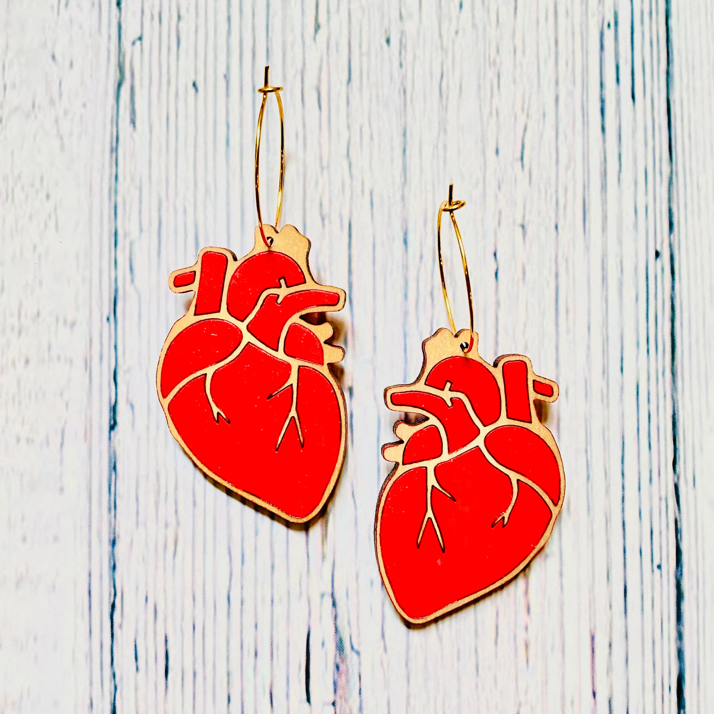 Red anatomical heart wooden hoop earrings.
