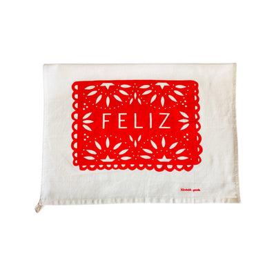 Feliz Tea Towel. Design features red papel picado that reads, "FELIZ."