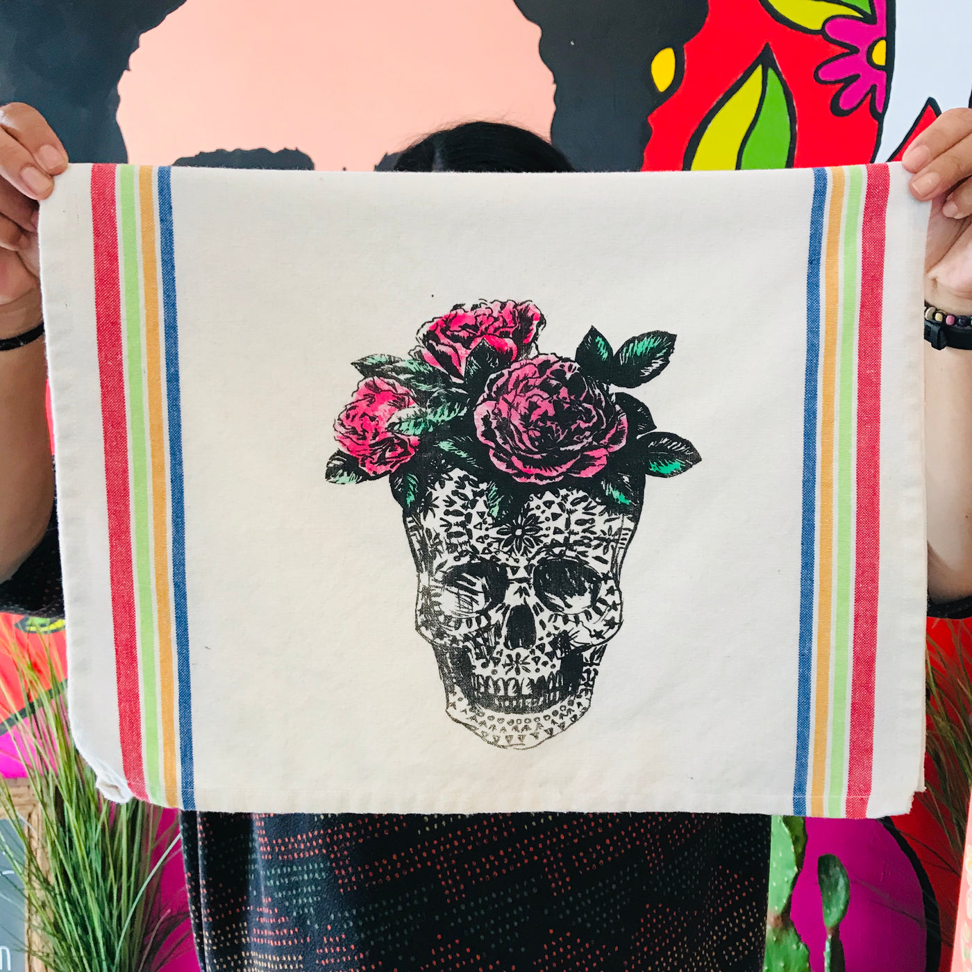 Loteria themed dish towels of a skull/la calavera and roses on its head