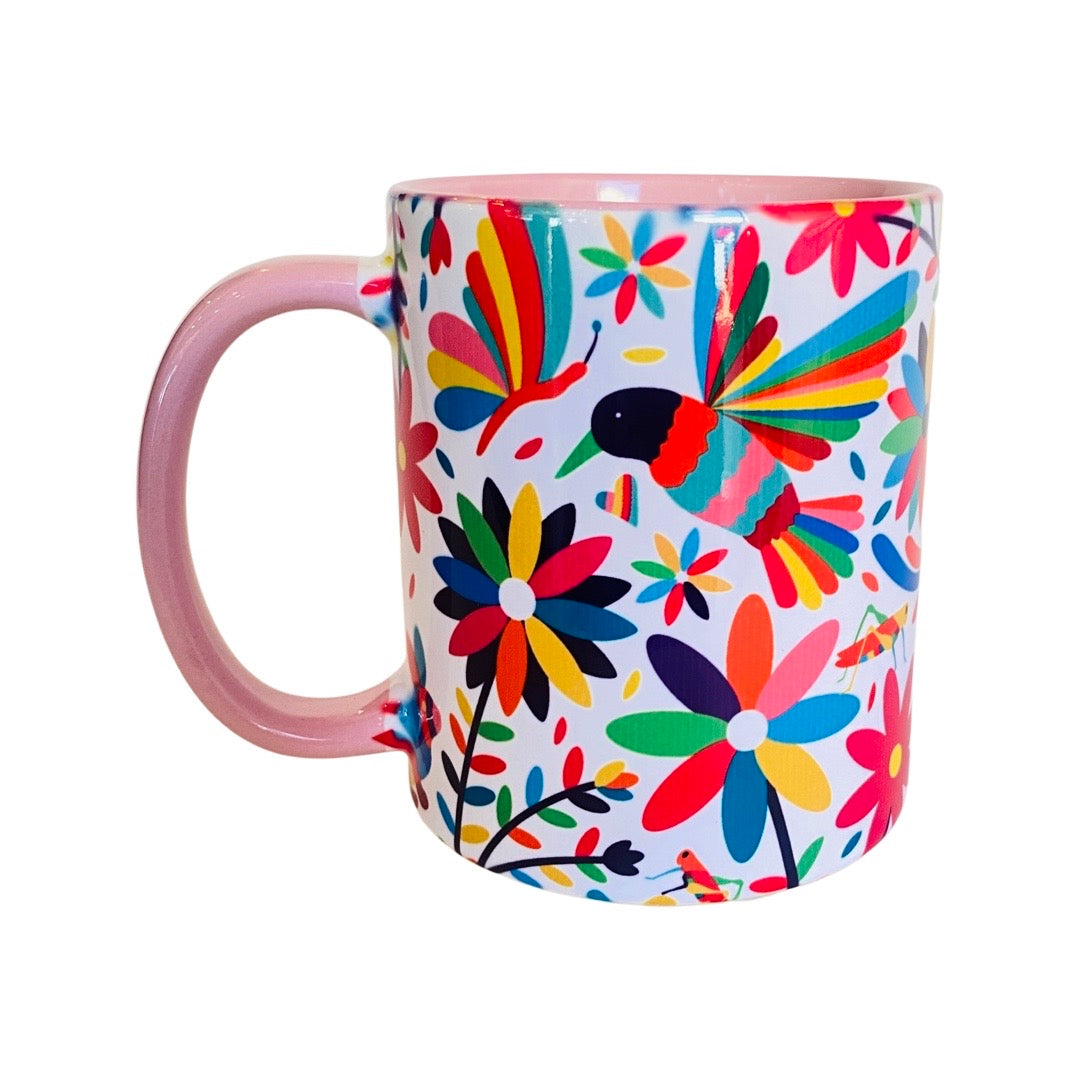 Colorful Otomi Mug with light pink handle. 